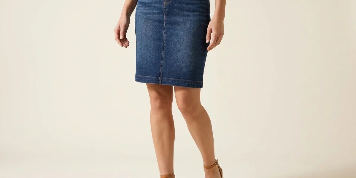 Cropped view of a woman modeling a medium-wash blue denim pencil skirt paired with ankle-strap wedge espadrilles.