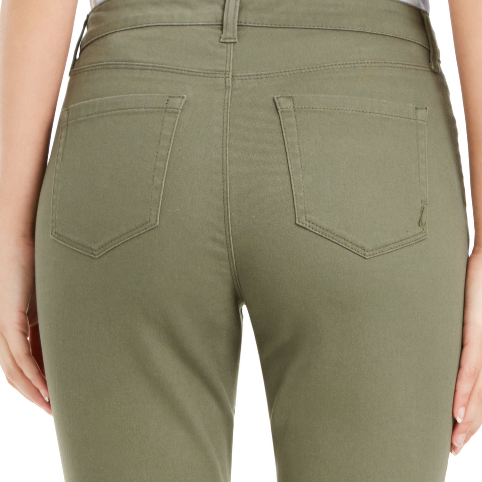 Close-up of olive green pants with a white shirt underneath on a plain background