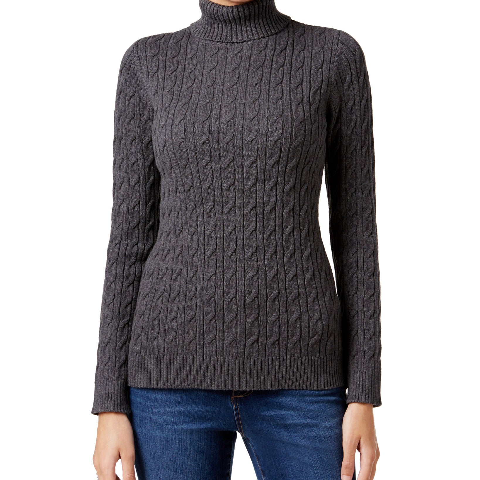 Person wearing a gray cable knit turtleneck sweater on a white background