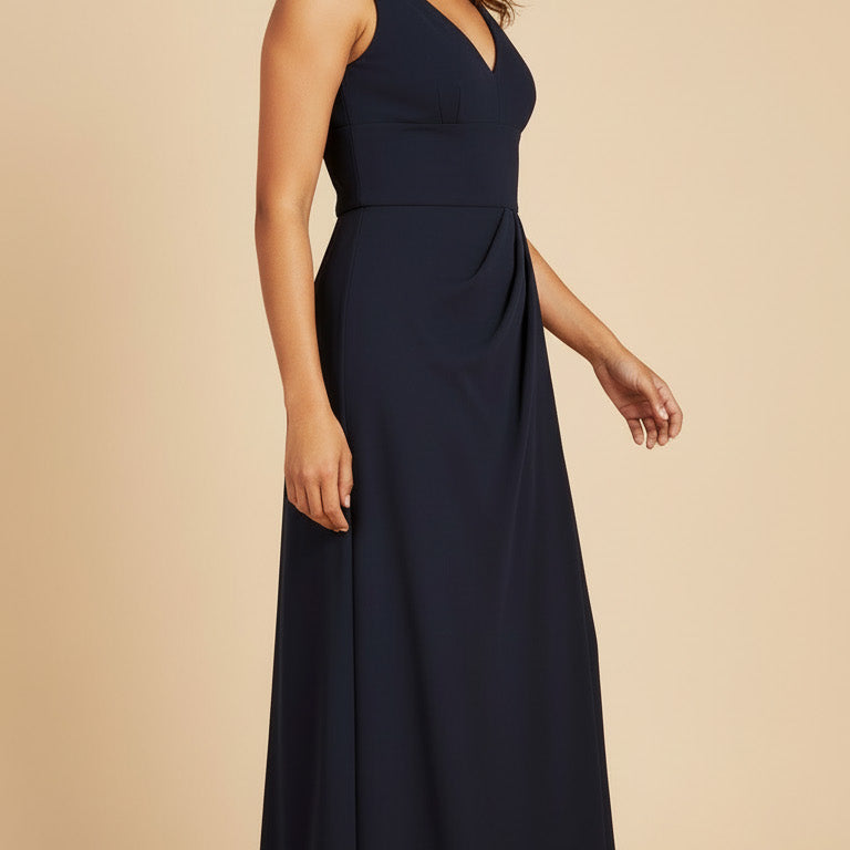 Woman wearing a navy blue sleeveless gown on a beige background