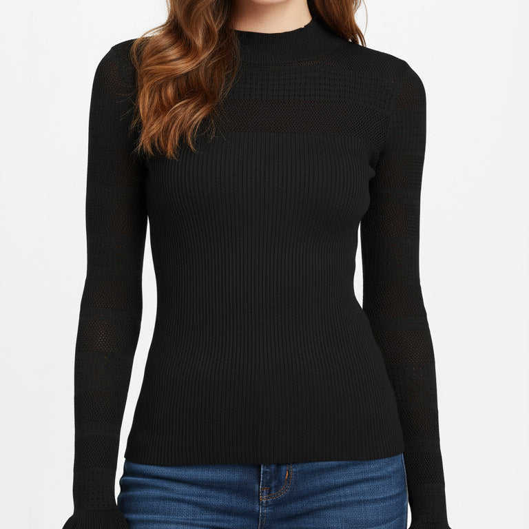 Woman wearing a black ribbed long-sleeve top and blue jeans on a white background