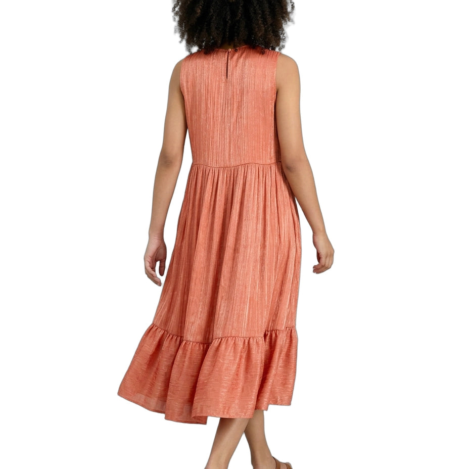 Woman wearing a coral dress on a white background