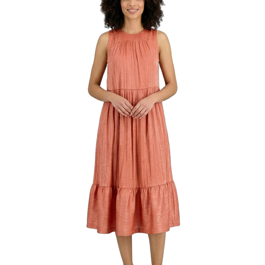 Woman wearing a coral dress on a white background