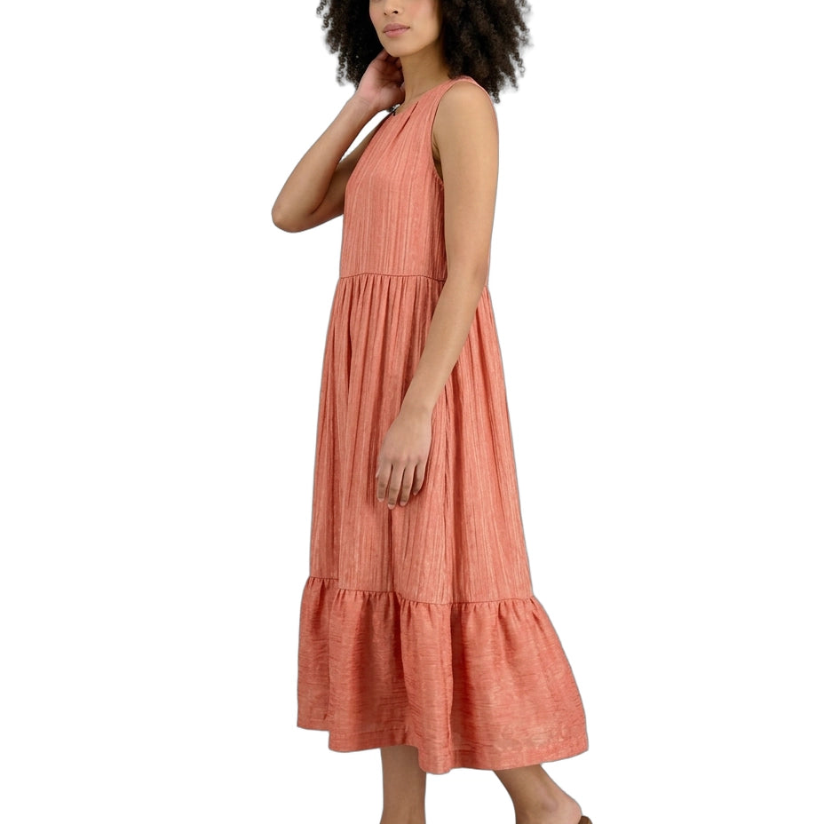 Woman wearing a coral dress on a white background