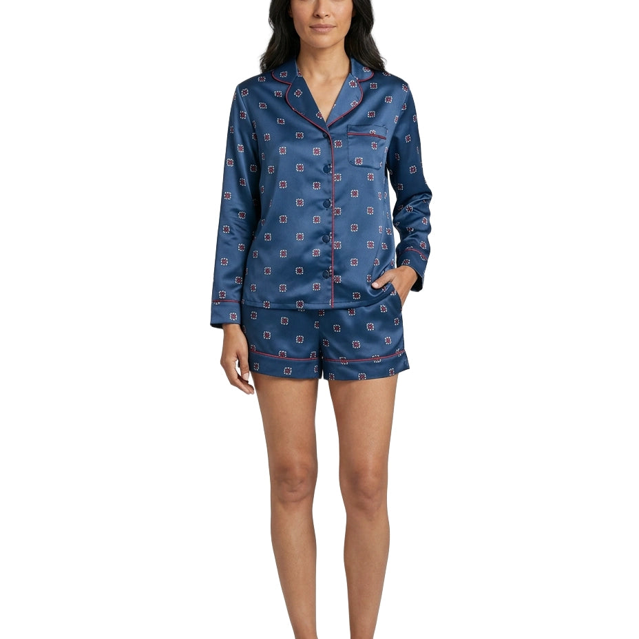 Woman wearing a blue patterned pajama set on a white background