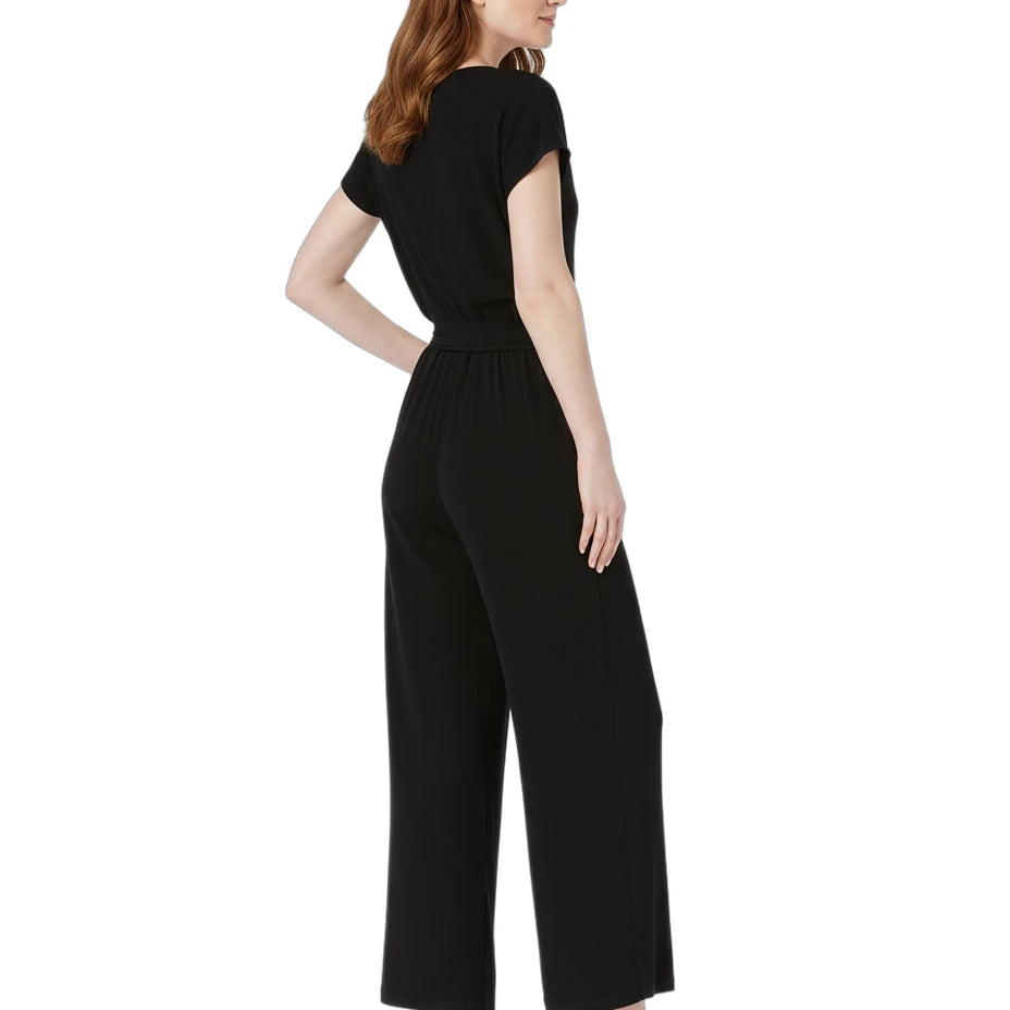 Woman wearing a black jumpsuit on a white background