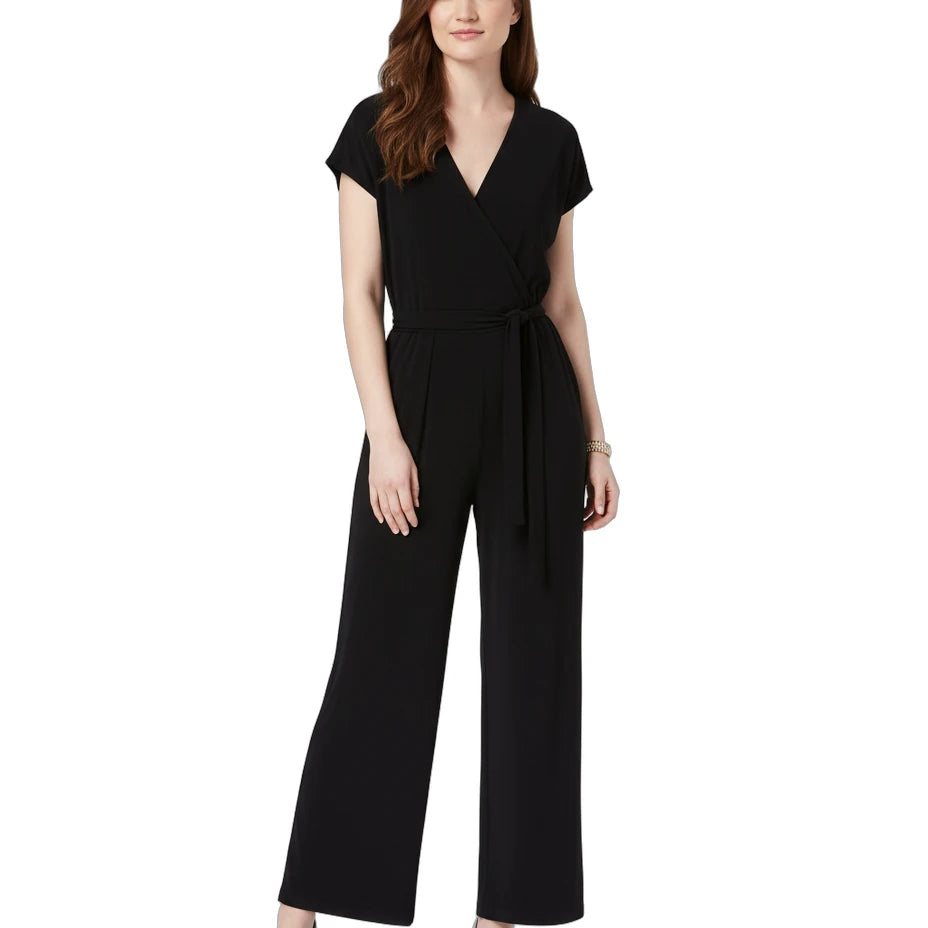 Woman wearing a black jumpsuit on a white background