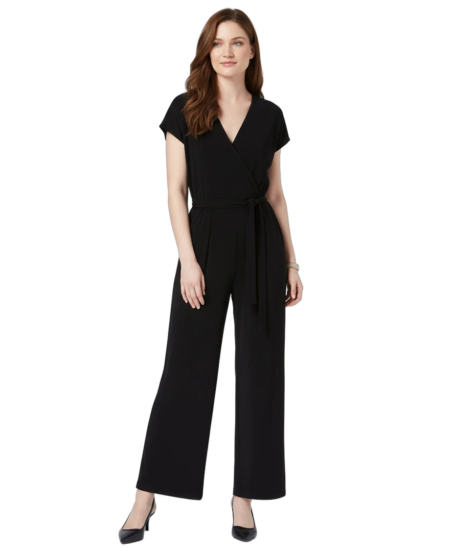 Woman wearing a black jumpsuit on a white background