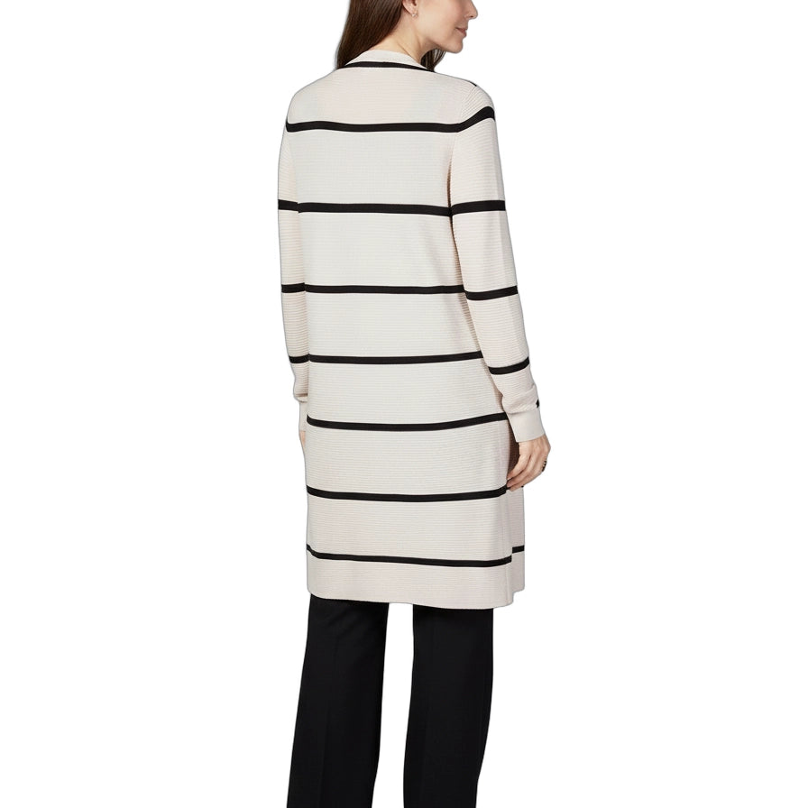 Woman wearing a long, striped sweater dress on a white background