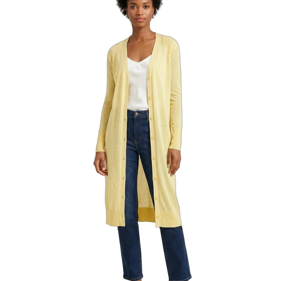 Woman wearing a long yellow cardigan over a white top and blue jeans on a white background
