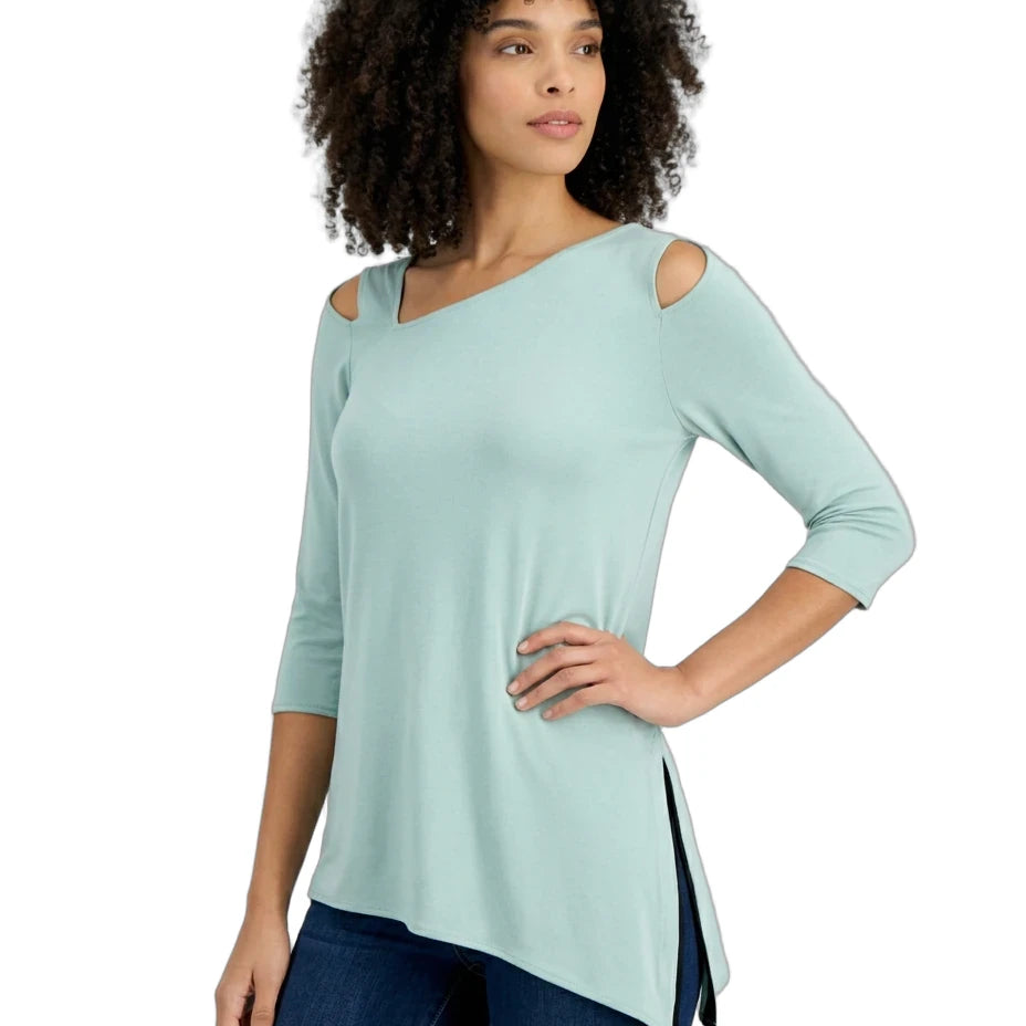 Woman wearing a light blue top with cut-out shoulders on a white background