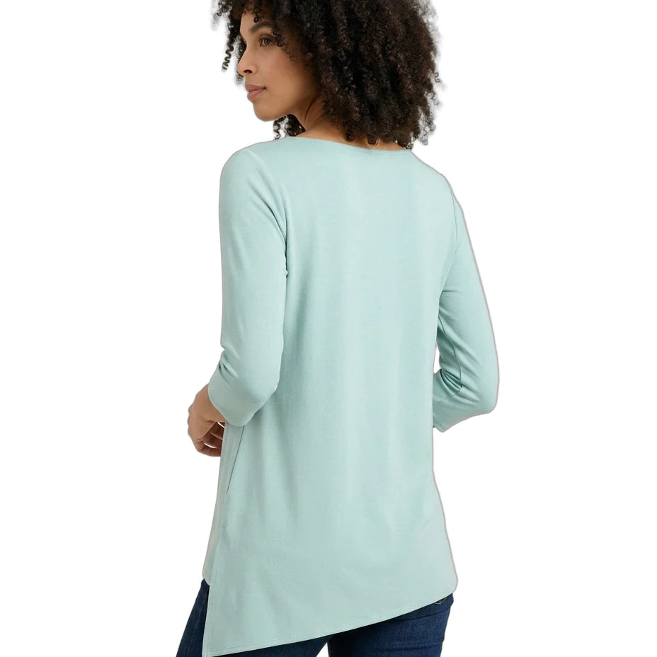Woman wearing a light blue long-sleeve top on a white background