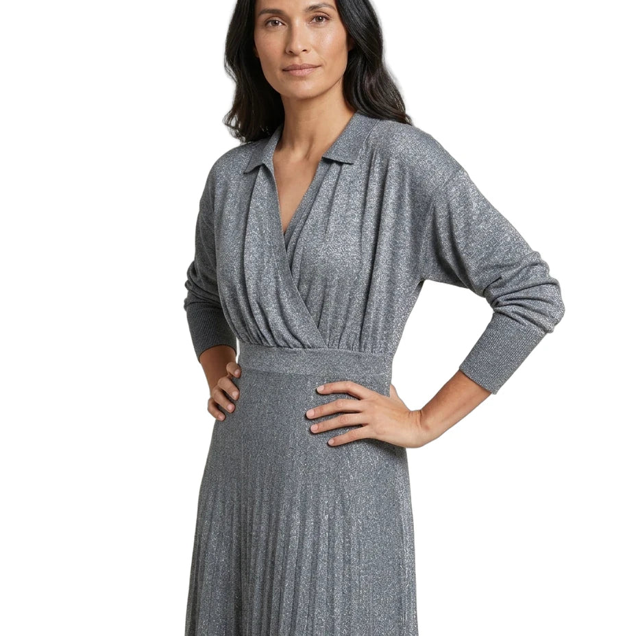 A woman modeling a long-sleeve gray knit wrap dress with a textured, shimmering finish, set against a plain white background.