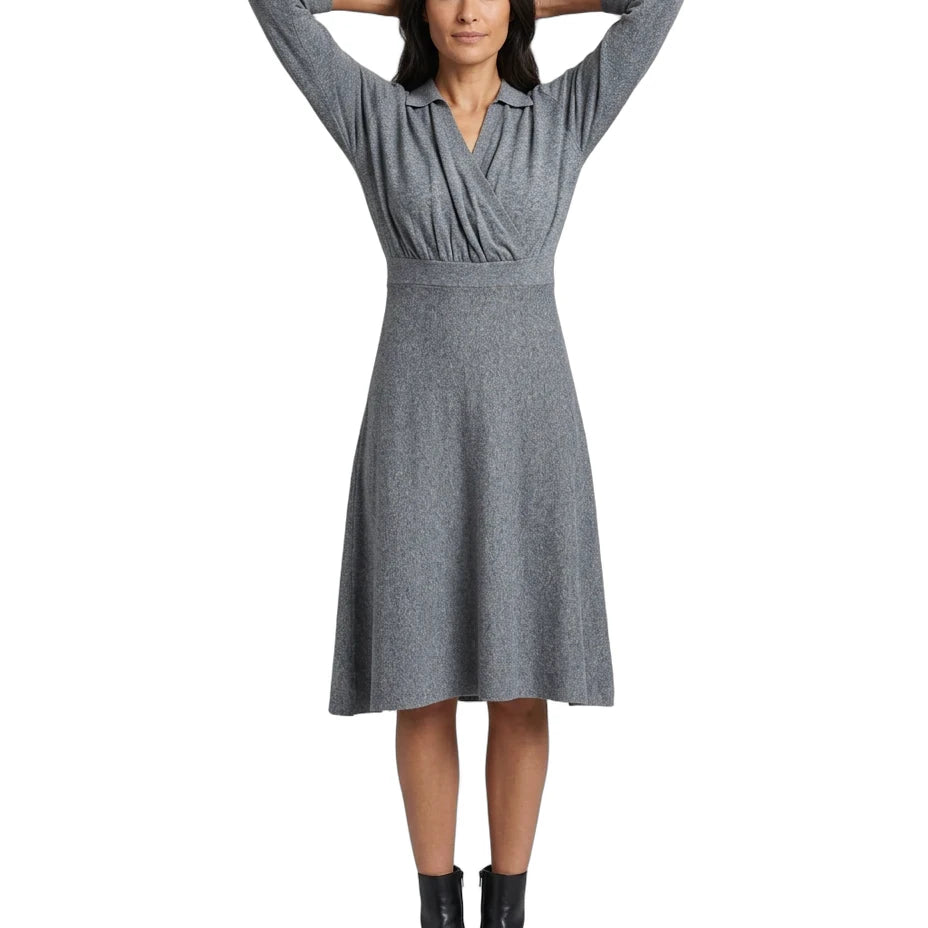 A woman modeling a gray long-sleeve wrap-style dress with a V-neckline and flared skirt, paired with black ankle boots, against a plain white background.