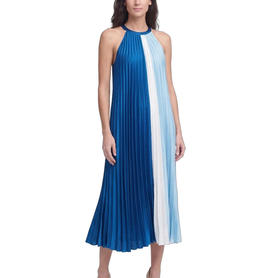A woman modeling a sleeveless halter-neck midi dress with vertical pleated stripes in royal blue, white, and light blue, paired with nude heels, against a plain white background.