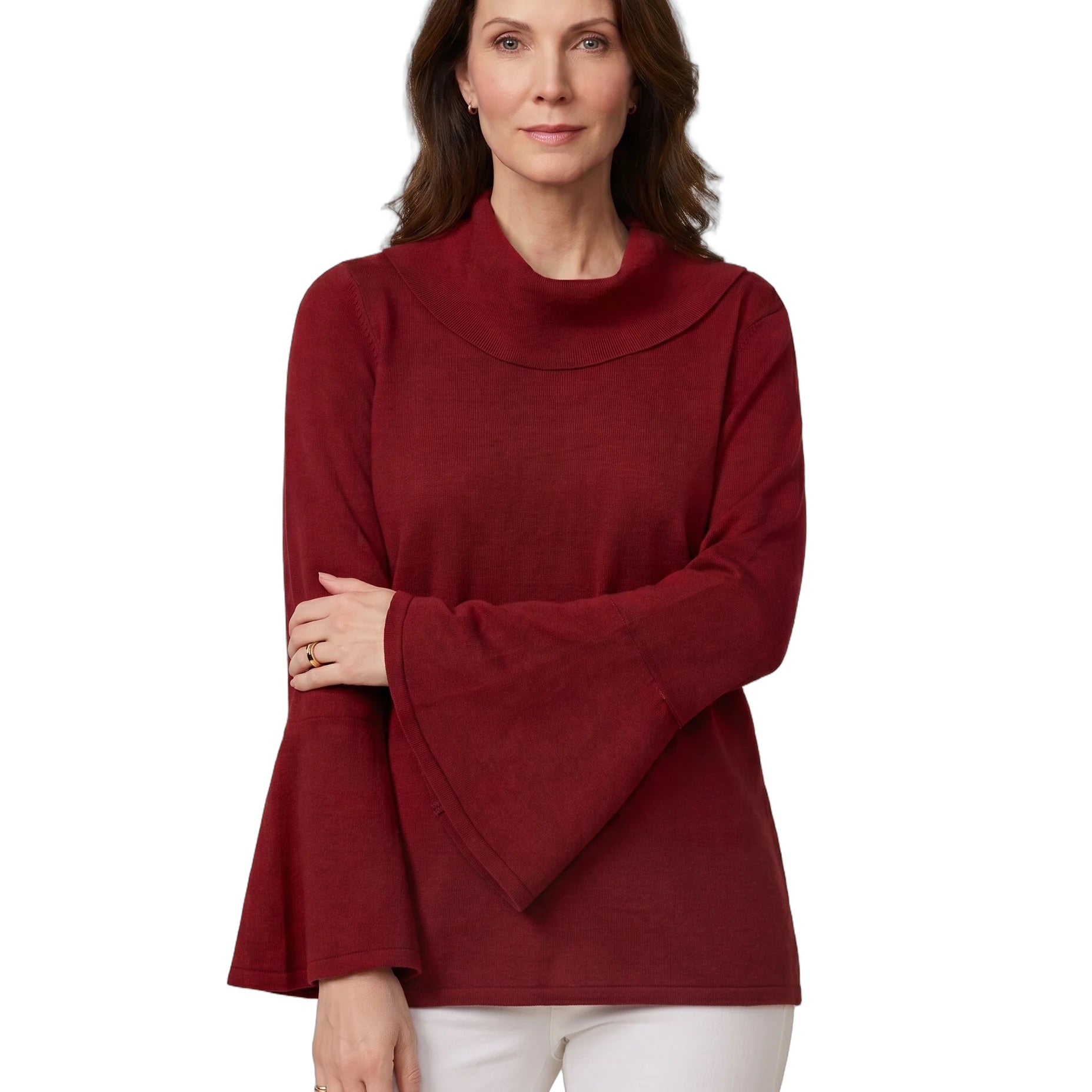 A woman modeling a long-sleeve knit top with a high folded mock neck and wide flared bell sleeves, in a deep burgundy red, paired with white pants against a plain white background.