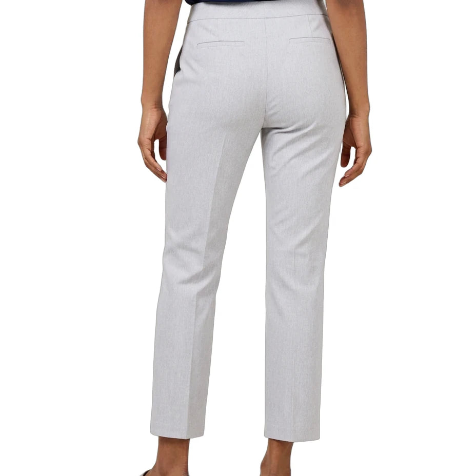 A person shown from the back wearing light gray cropped trousers, a navy top, and metallic silver loafers against a plain white studio background.