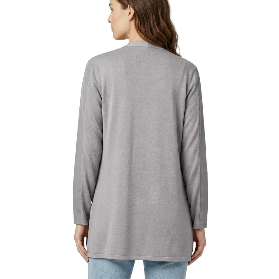 Woman wearing a gray long-sleeve top on a white background