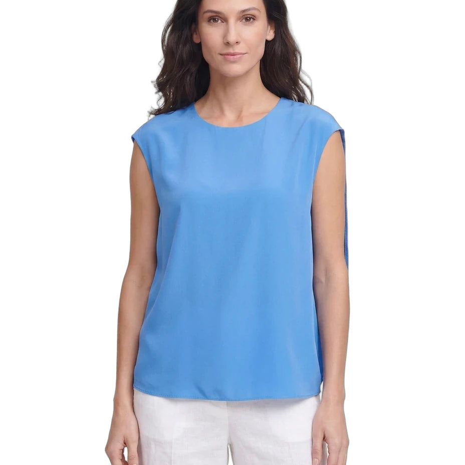 Woman wearing a blue sleeveless top on a white background