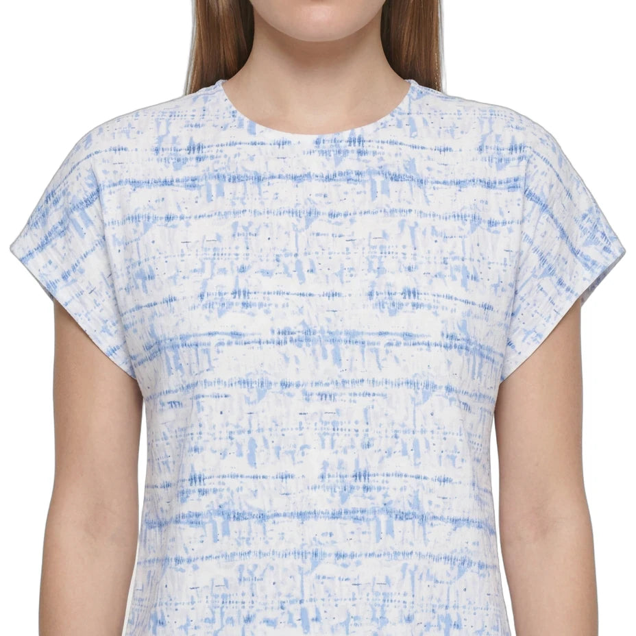 A woman wearing a short-sleeve crewneck top with a blue and white abstract horizontal stripe pattern, shown against a plain white background.