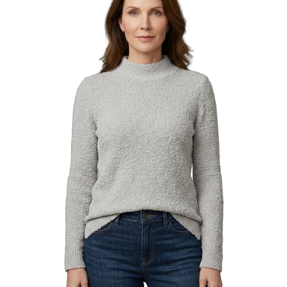 Woman wearing a gray sweater and blue jeans on a white background