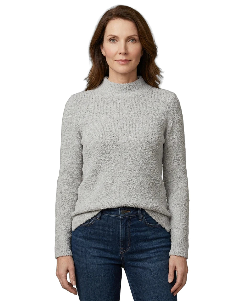 Woman wearing a gray sweater and blue jeans on a white background