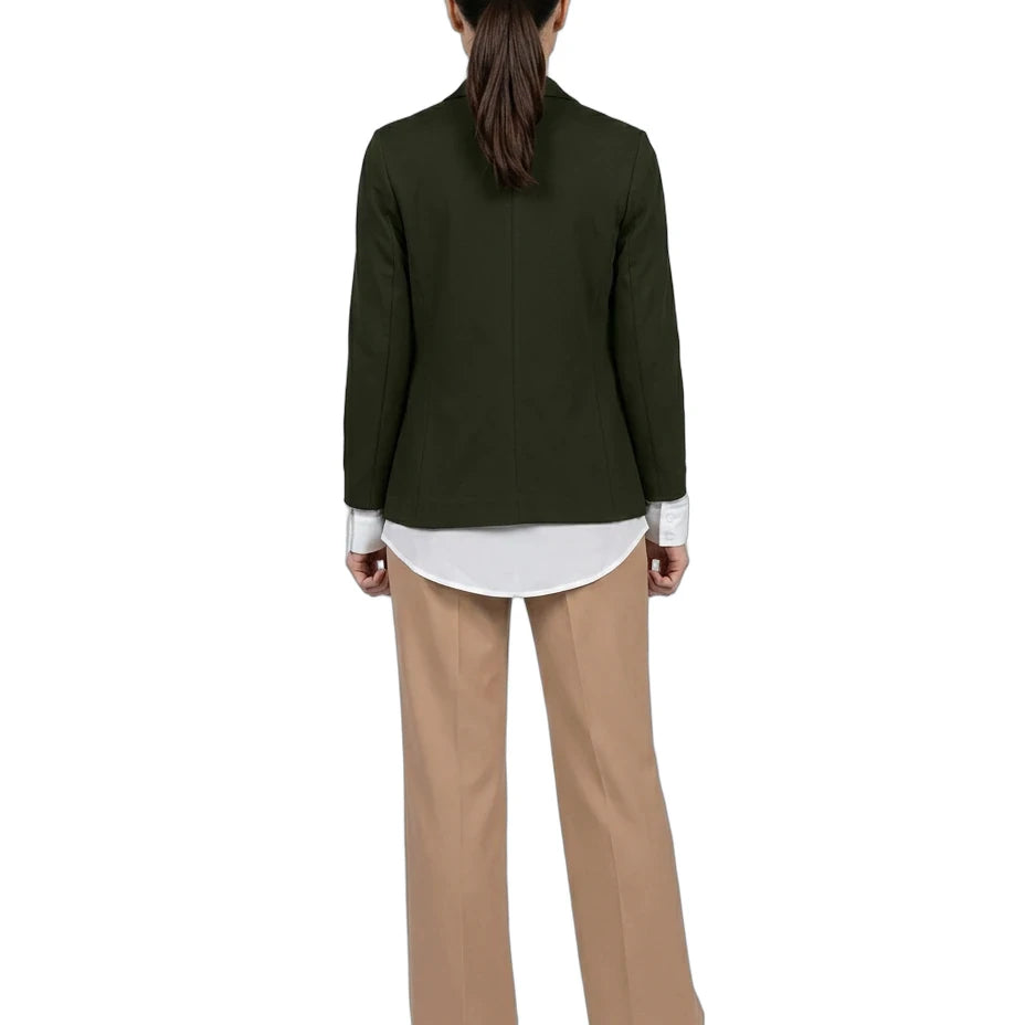 A model shown from the back wearing an olive green blazer over a white shirt, paired with beige wide-leg trousers and white sneakers, against a plain white background.