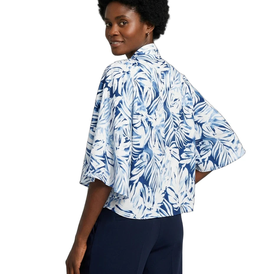 Woman wearing a blue and white floral kimono-style shirt on a white background