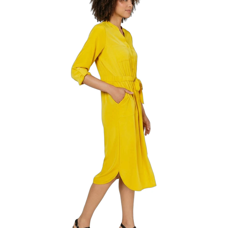A woman modeling a bright yellow midi dress with three-quarter sleeves, a tie waist, and side pockets, paired with black strappy sandals against a plain white background.