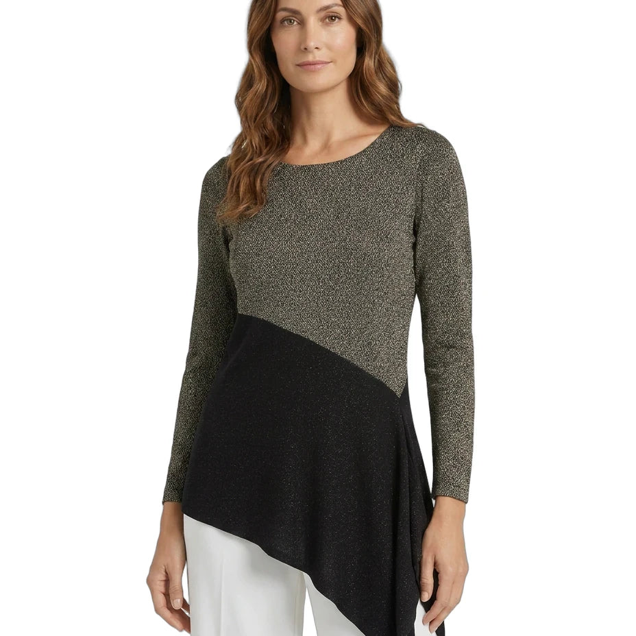 A woman modeling a color-block knit top with a textured olive green upper section and sleeves, a solid black diagonal lower panel, and white pants against a plain white background.