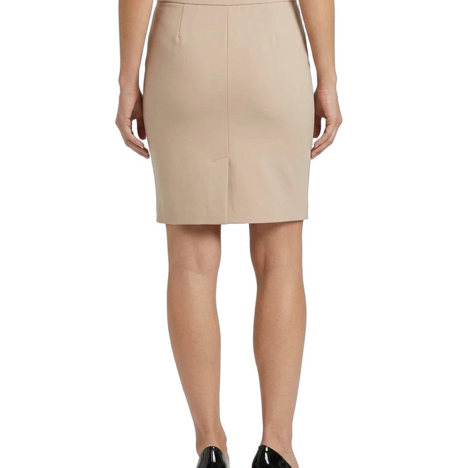 A woman shown from the back wearing a beige knee-length pencil skirt with a front center seam, paired with a black top and black patent leather block heels, against a plain white background.