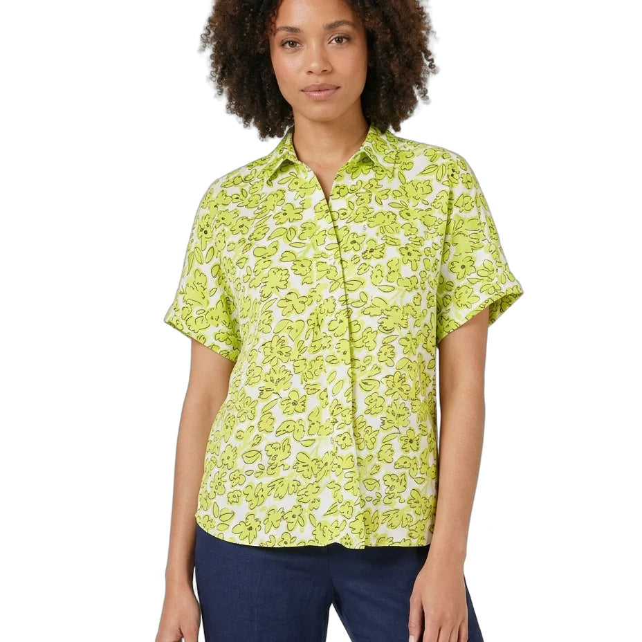 Woman wearing a green patterned shirt on a white background