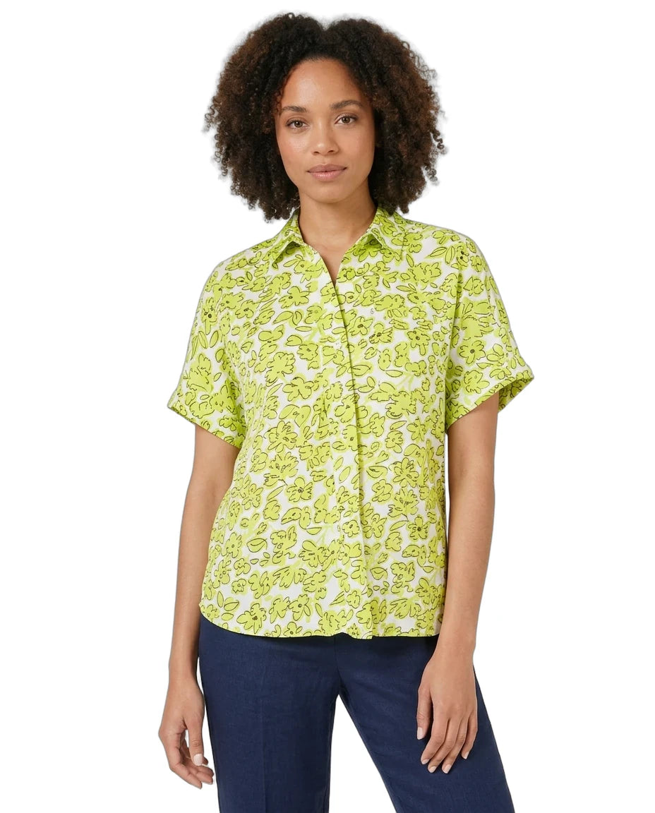 Woman wearing a green patterned shirt on a white background