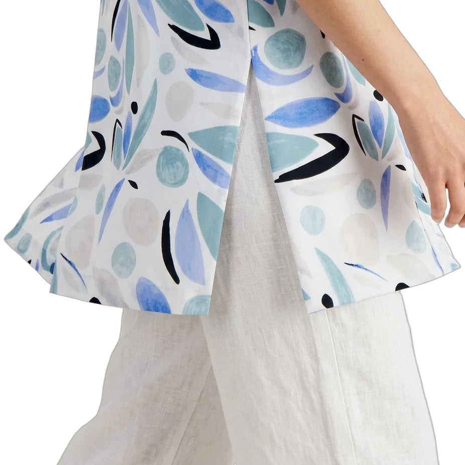 White blouse with blue and black leaf pattern worn by a person