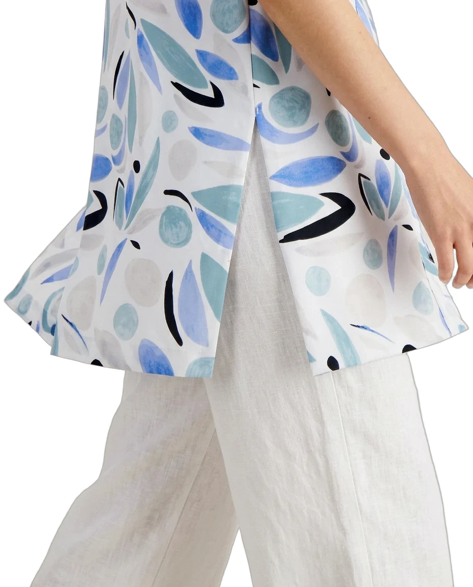 White blouse with blue and black leaf pattern worn by a person