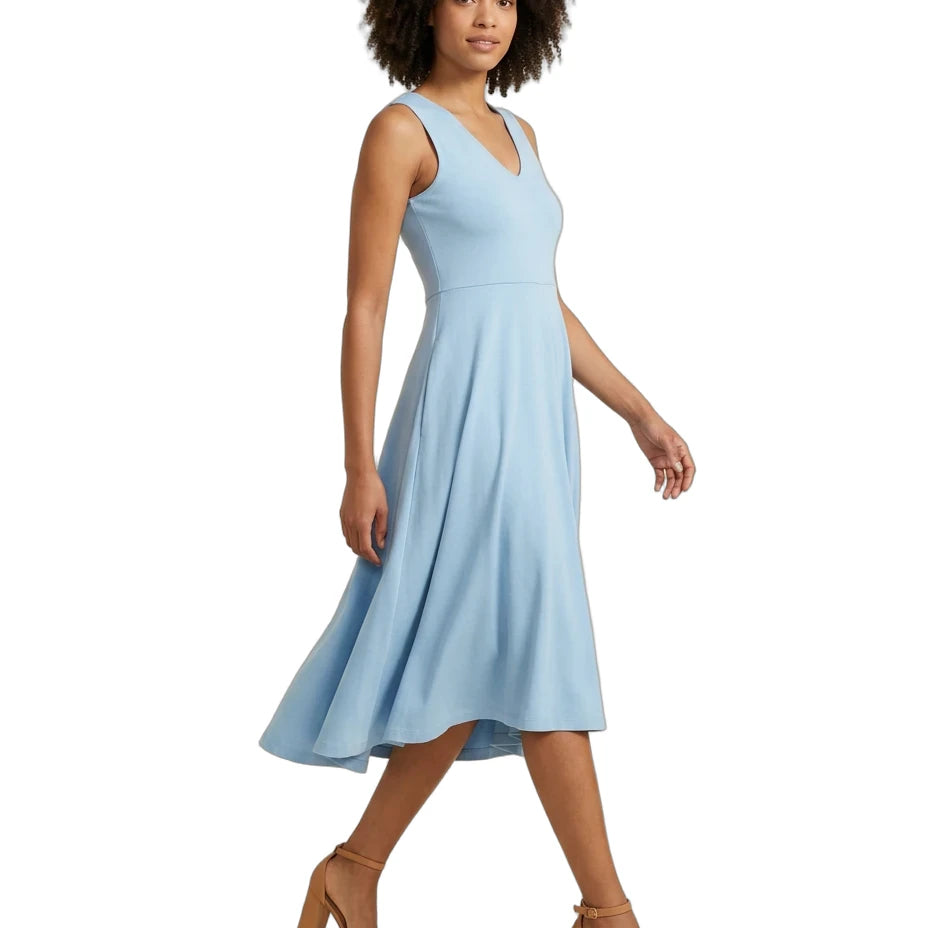 A woman modeling a sleeveless light blue V-neck midi dress with a flared skirt, paired with tan heeled sandals, against a plain white background.