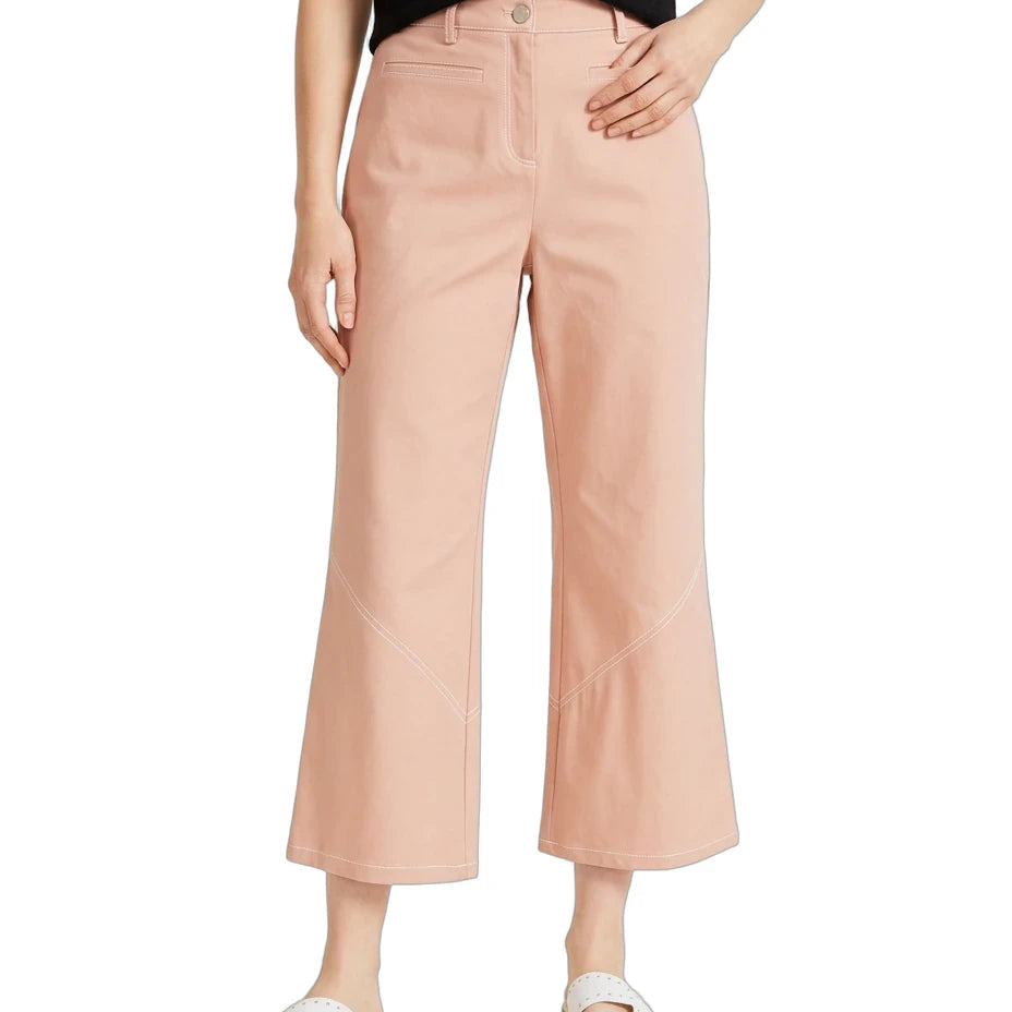 A model wearing a pair of light peach-colored cropped wide-leg pants, styled with a black top and white slide sandals, against a plain white background.