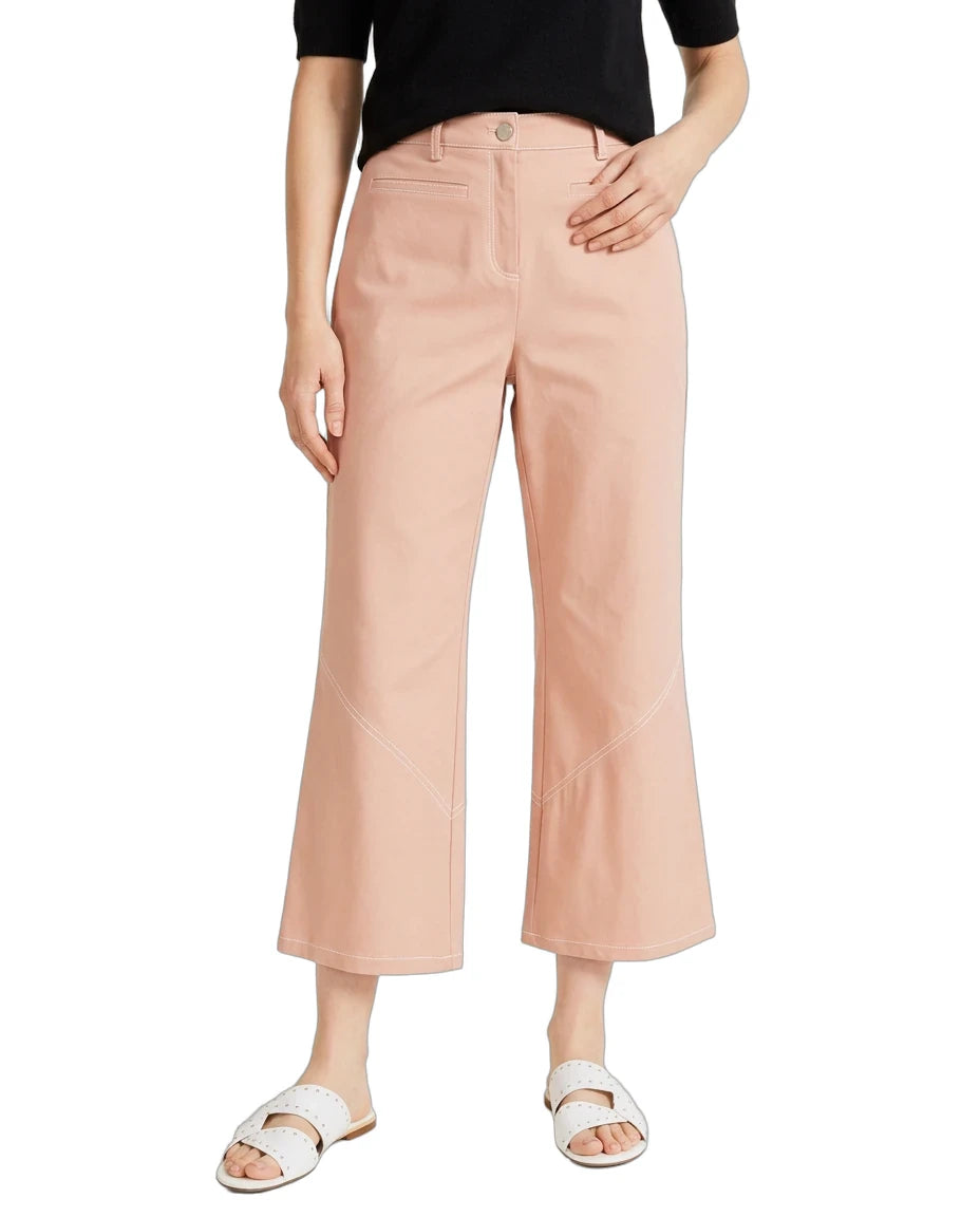 A model wearing a pair of light peach-colored cropped wide-leg pants, styled with a black top and white slide sandals, against a plain white background.
