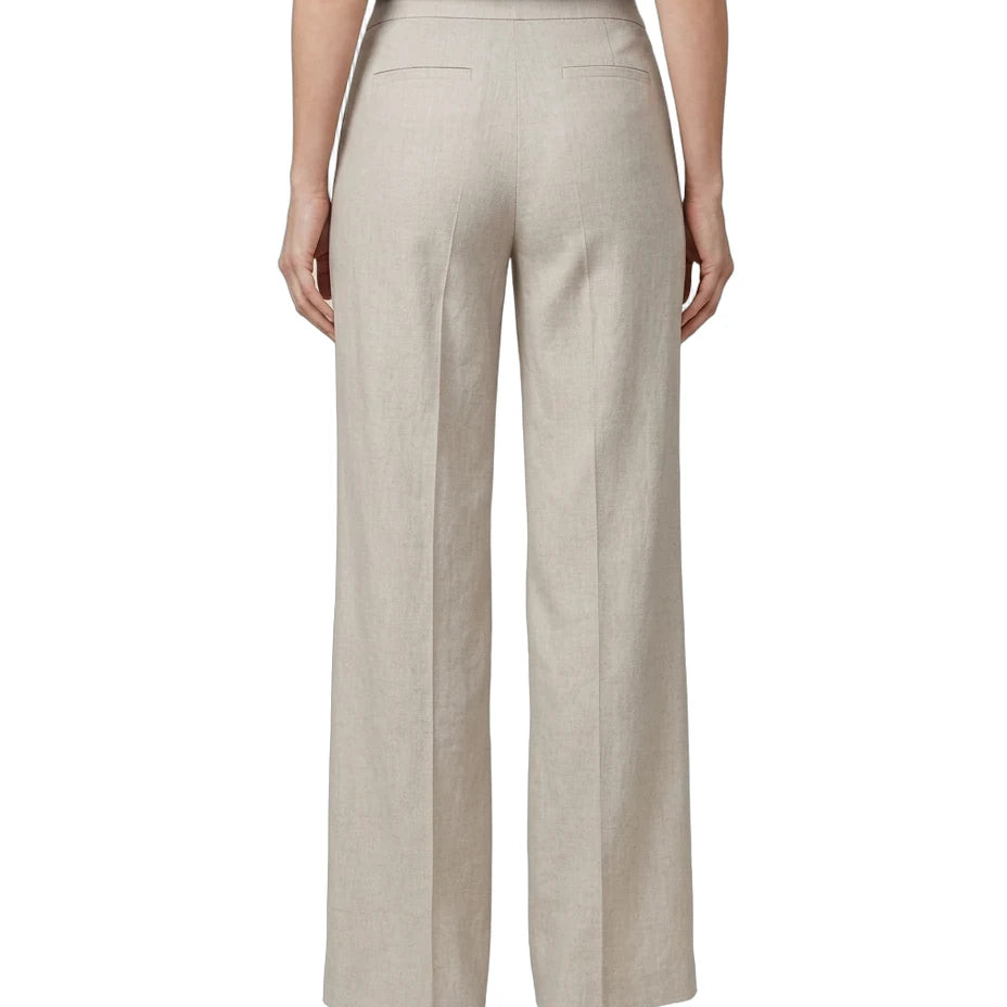 A model shown from the back wearing high-waisted, wide-leg trousers in a light beige linen-like fabric, paired with a black top and white heels, on a solid white background.