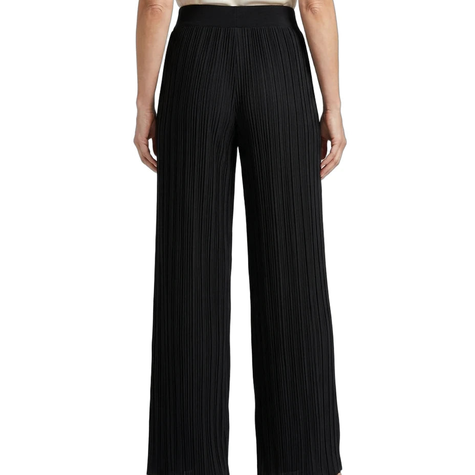 Black pleated wide-leg trousers shown from the back on a model, paired with a cream top and metallic silver heels, against a plain white background.