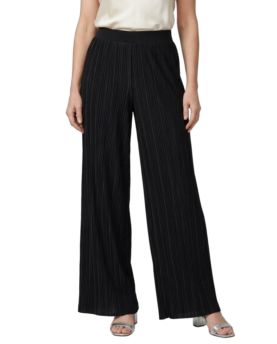 Black wide-leg pleated trousers with a black waistband, shown on a model wearing a cream top and silver sandals against a white background.