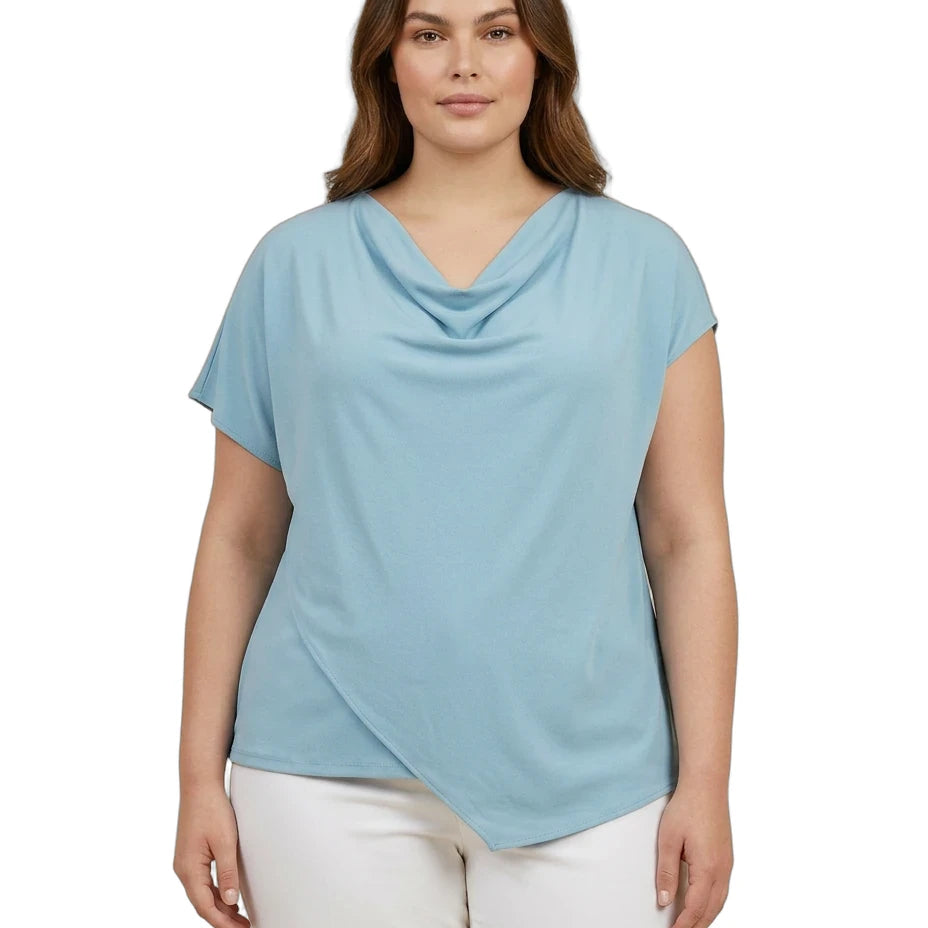 Woman wearing a light blue cowl-neck top and white pants on a white background