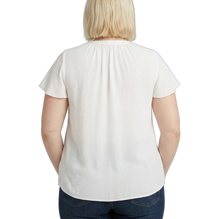 Person wearing a white blouse and blue jeans on a white background