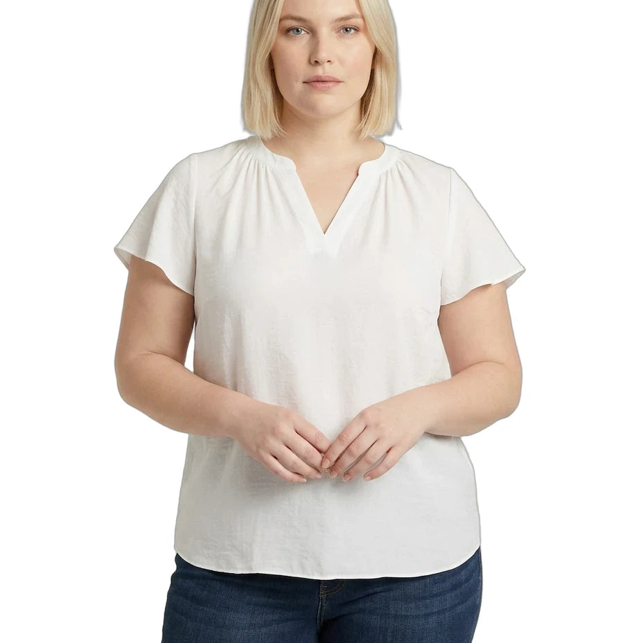 Woman wearing a white blouse and blue jeans on a white background