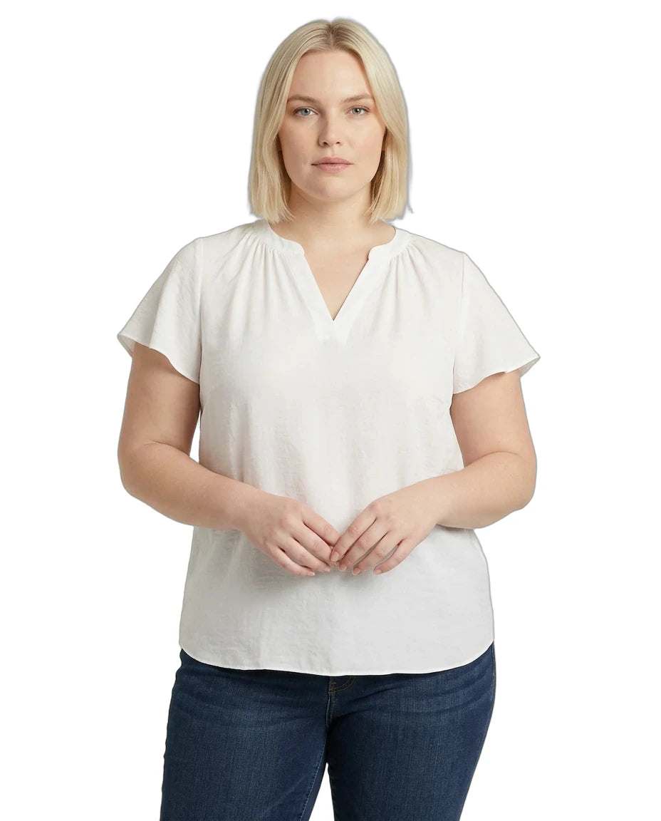 Woman wearing a white blouse and blue jeans on a white background