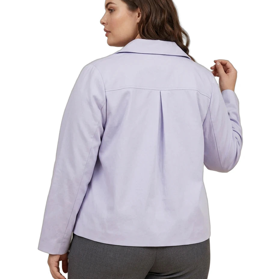 A woman shown from the back wearing a light lavender long-sleeve collared shirt and gray pants against a plain white background.
