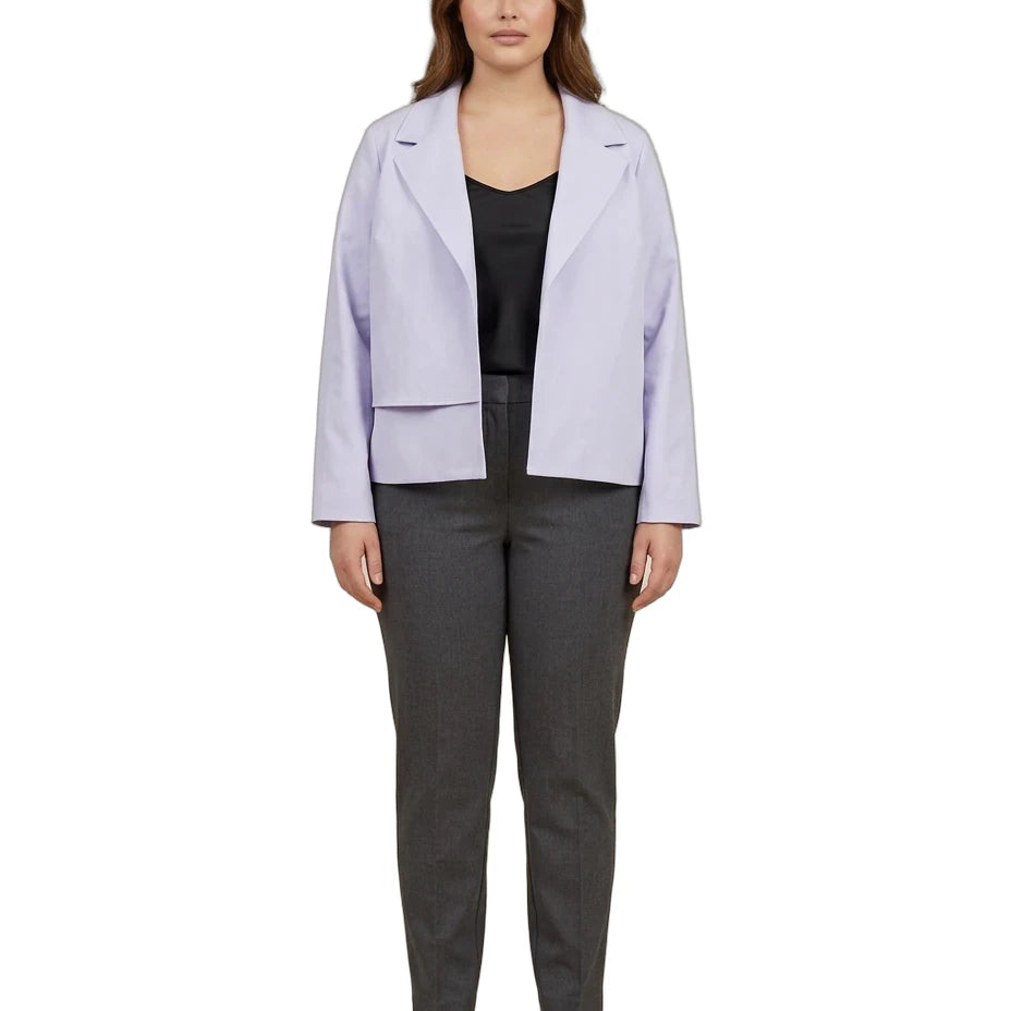 A woman modeling a light lavender blazer over a black top and dark gray trousers, standing against a plain white background.