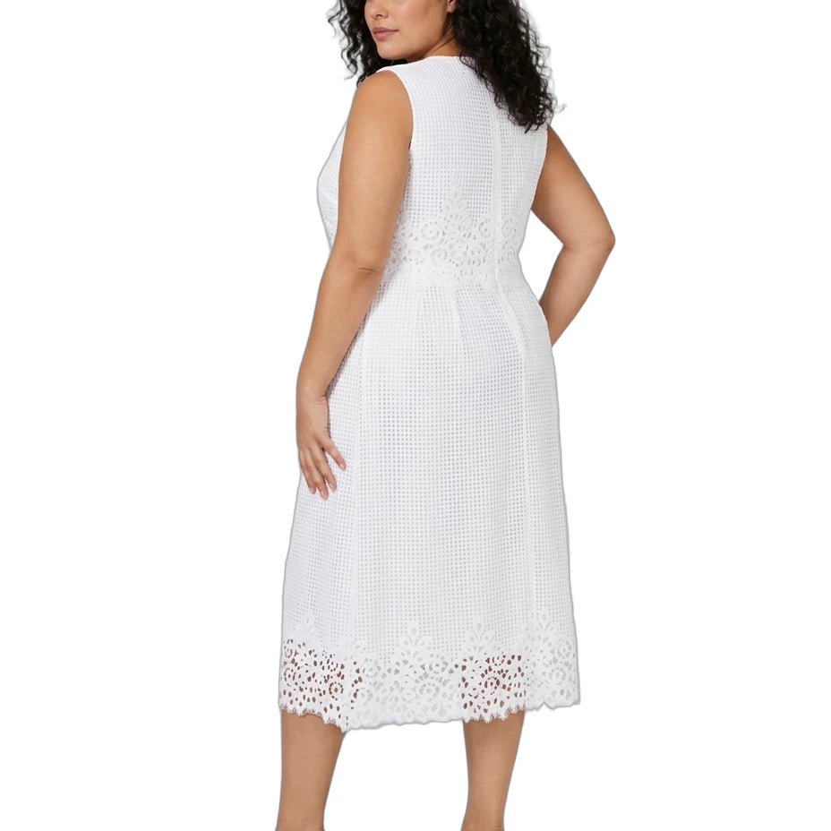 A woman modeling a sleeveless white midi dress with a textured eyelet pattern and lace trim, shown from the back against a plain white background.
