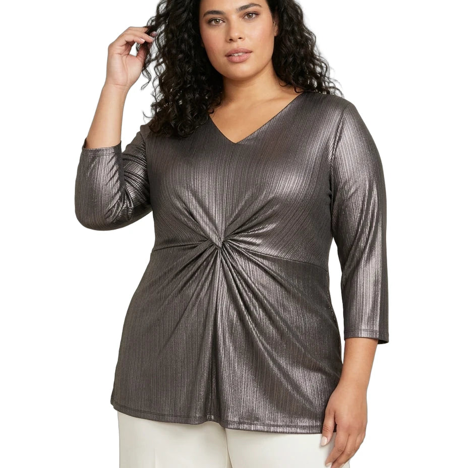 Woman wearing a metallic gray top with a knot detail on a white background