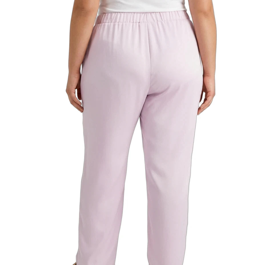 A person shown from the back wearing light pink wide-leg trousers with an elastic waistband, paired with a white top and tan flat shoes, against a plain white background.